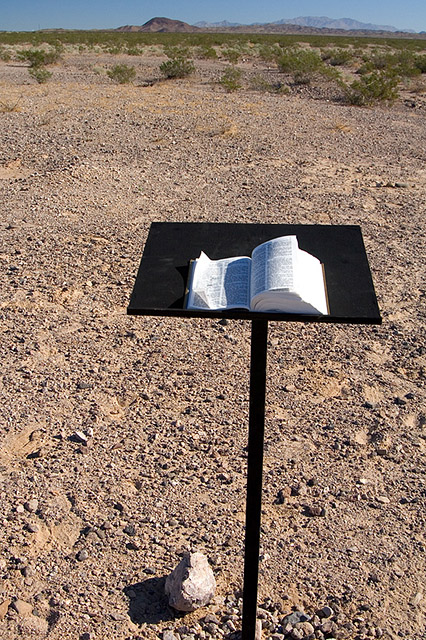 image of bible on lecturn in the middle of the desert