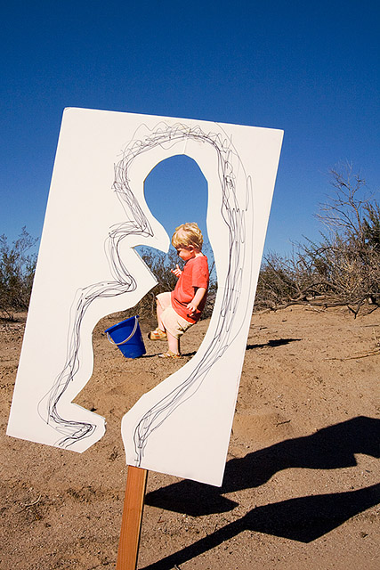 cutout surrounding toddler kicking the bucket